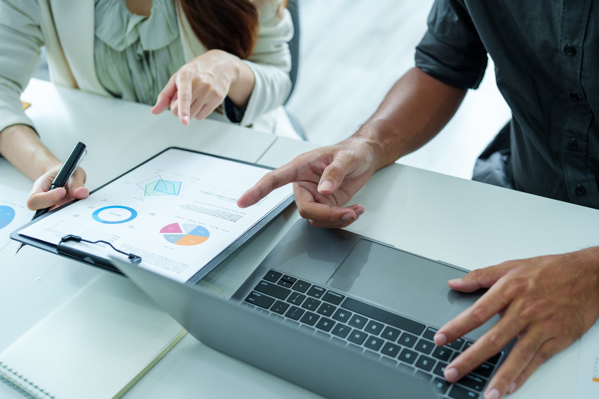 A portrait of a female marketer and a male salesperson discussing how to increase sales by investing in new products to expand marketing using documents and computers in working, new idea product