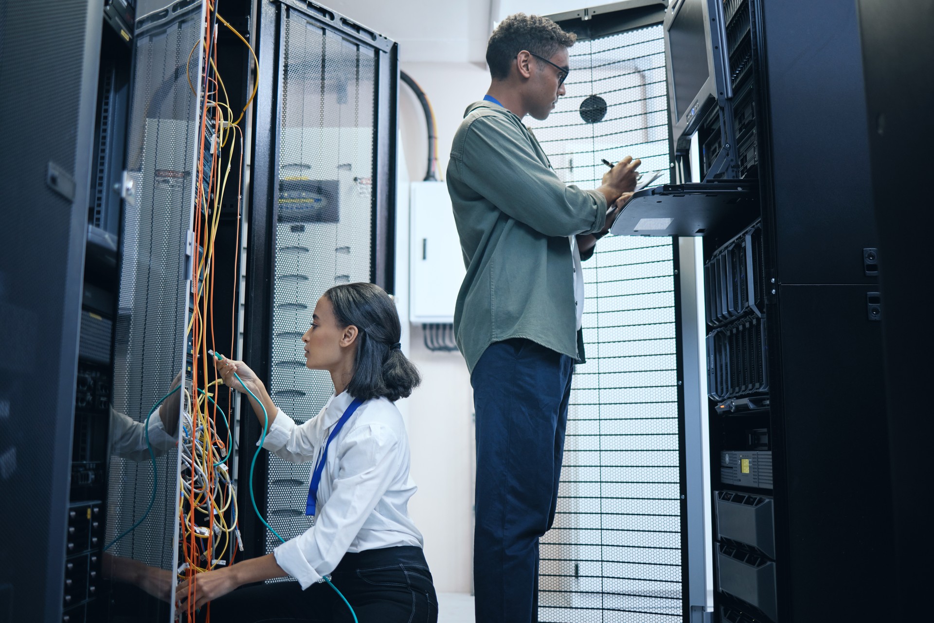 Cropped shot of two young computer programmers working together in a server room